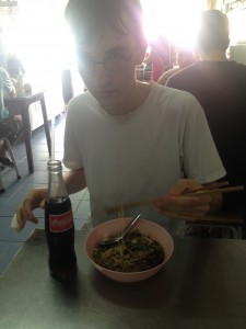 Eating duck noodle soup in a roadside restaurant, Bangkok